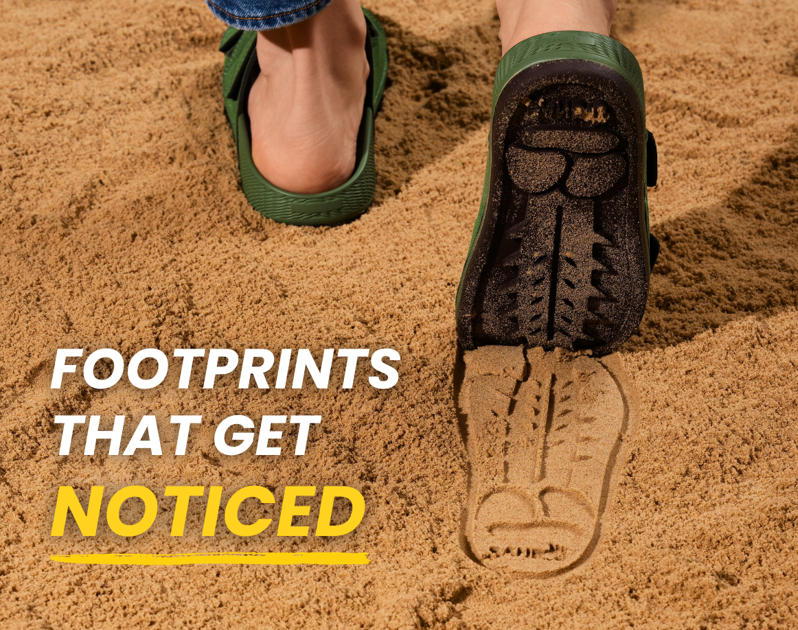 Green Sand-U Footprint sandals walking on the sand and leaving a bold signature sole print. 