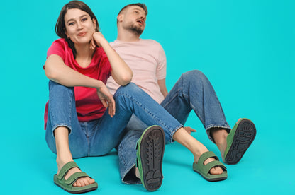 Couple wearing Sand-U footprint sandals on the beach