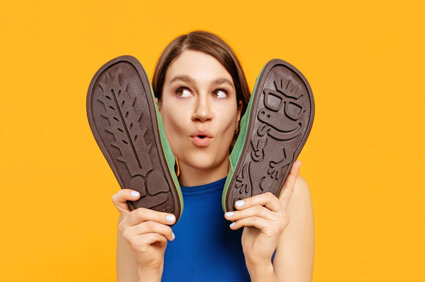 Woman holding footprint Sand-U sandals showing sole pattern