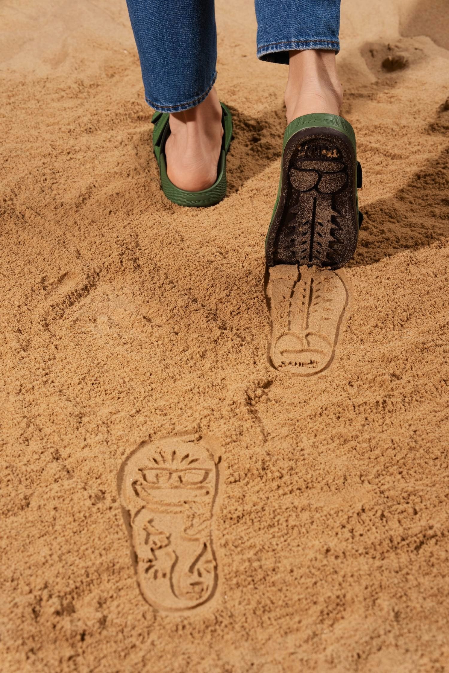 footprint sandals leaving footprints in sand on beach